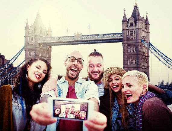 Selfie in London with Tower Bridge in the background via shutterstock