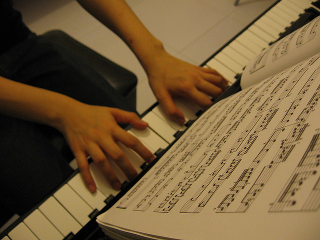 Playing the piano via flickr by Calvin Che